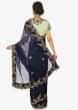 Navy blue organza saree  paired with a contrasting Pista green raw silk blouse