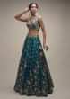 Ocean Green Lehenga Choli In Raw Silk With Colorful Resham Embroidered Spring Blossoms 