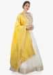 Off white anarkali dress paired with a weaved yellow dupatta  only on kalki