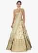 Off white raw silk lehenga with sequins and cut dana in paisley motifs