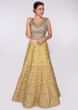 Olive green blouse paired with butter yellow heavy embroidered lehenga and coral peach net dupatta