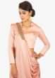 Peach milano satin pant with presttiched pleated applique dupatta paired with a matching peach blouse