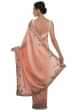 Peach satin chiffon saree with floral motif embellished with zari and sequins only on Kalki