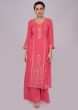 Pink georgette suit with zari embroidery in center panel and side butti