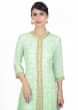 Pista green cotton suit in embroidered butti paired with cotton skirt in lace highlight