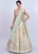 Pista green jute lehenga intricated in thread embroidery and butti only on Kalki