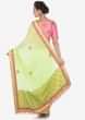 Pista green saree adorn in zardosi butti and foil printed border only on Kalki