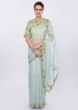 Powder blue organza saree with  contrasting pista green raw silk blouse only on kalki