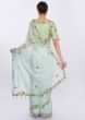 Powder blue organza saree with  contrasting pista green raw silk blouse only on kalki