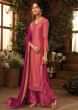 Punch pink unstitched suit paired with  floral weaved bottoms and chiffon dupatta with brocade border