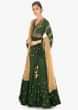 Rama green lehenga paired with embellished peplum top and a contrasting beige net duppata 