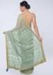 Sage green half and half saree featuring in satin and net 