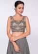 Smoke grey georgette skirt paired with embroidered net top and grey chiffon wrap around 