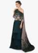 Teal green layered skirt matched with fancy cape blouse in velvet applique work