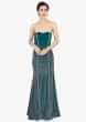 Teal green strapless fish cut gown with long net cape 