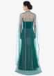 Teal green strapless fish cut gown with long net cape 