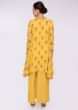 Tuscan yellow asymmetric top in floral printed butti paired with a plain georgette palazzo 