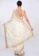 White linen saree with embroidered butti and border only on Kalki