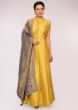 Yellow brocade anarkali dress matched with a grey georgette weaved dupatta 