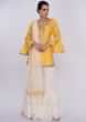 Yellow suit with white sharara and net dupatta only on Kalki
