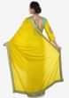 Yellow saree in cotton with ready stitched blouse embellished in zari butti embroidery only on Kalki