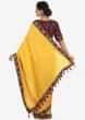Yellow saree in satin silk with a navy blue blouse embroidered with zardosi and thread work only on Kalki