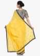 Yellow saree in silk with ready stitched blouse beautified in resham and cut dana work only on Kalki