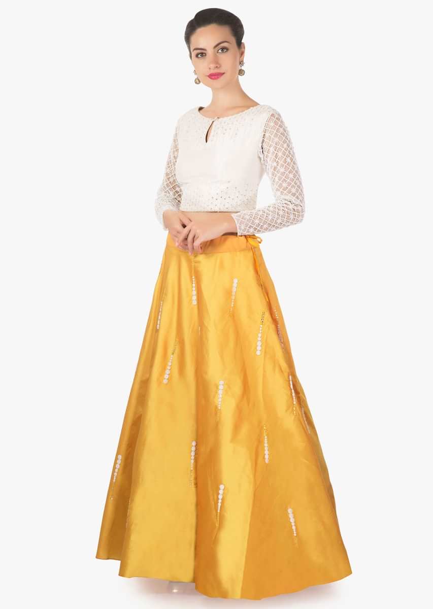 Daffodil yellow lehenga in silk with cream blouse in moti embroidered sleeve only on Kalki