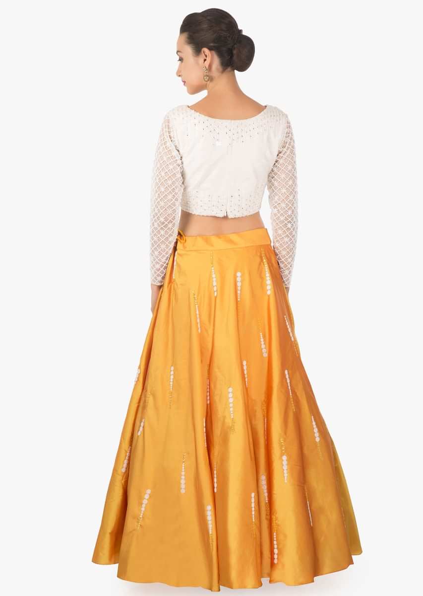 Daffodil yellow lehenga in silk with cream blouse in moti embroidered sleeve only on Kalki