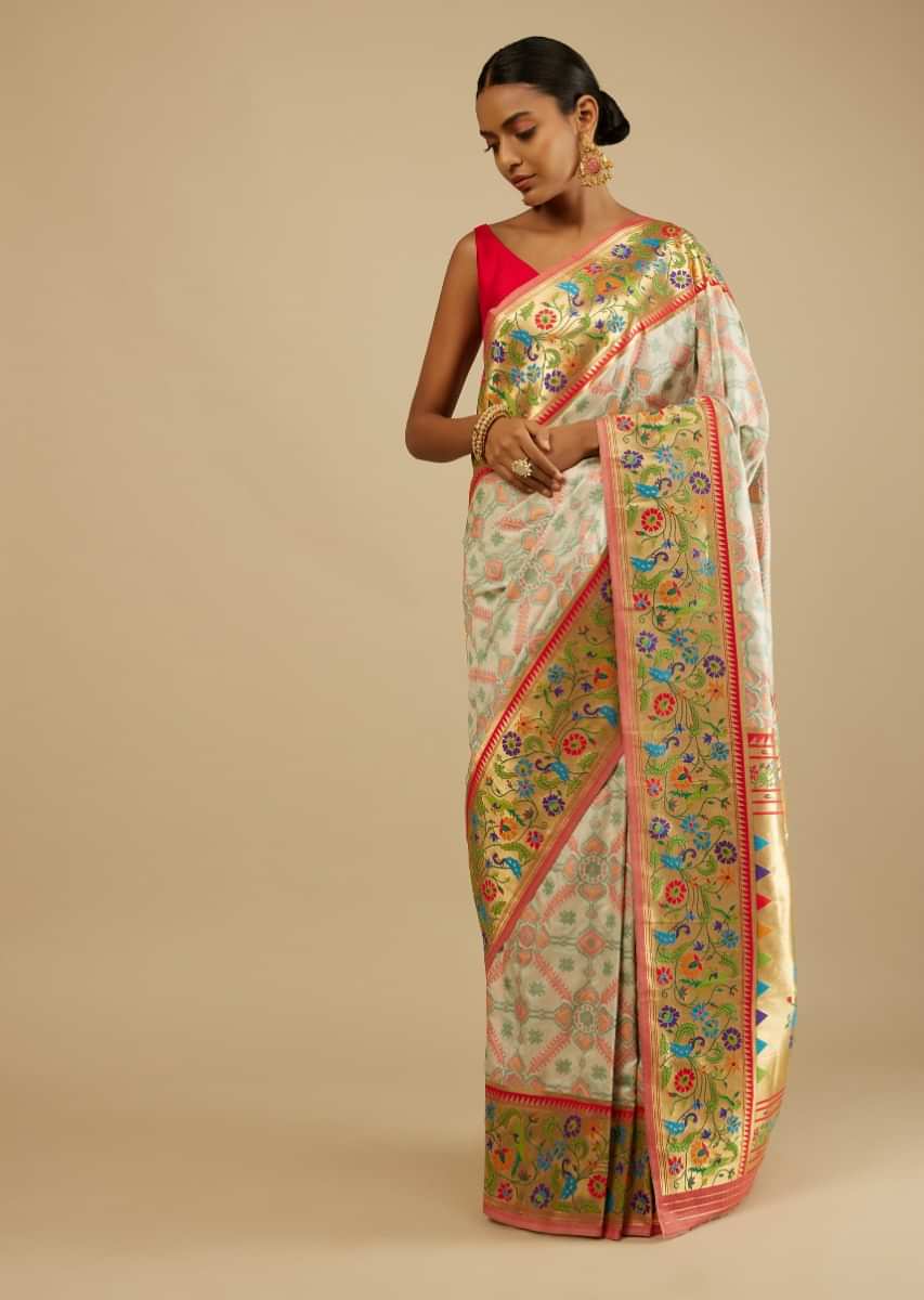 Daisy White Saree In Silk Blend With Woven Patola Jaal And A Gold Border With Woven Colorful Peacock Motifs 