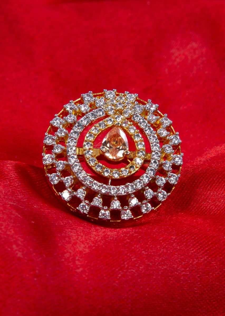 Diamond studded ring with cut work along honey gold stone at the center only on kalki
