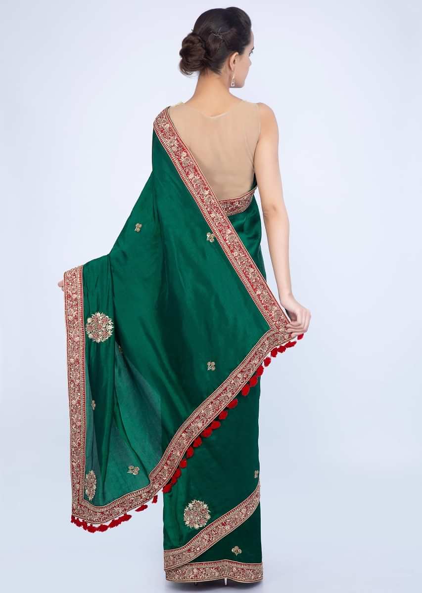 Emerald green silk saree with embroidered butti and border only on Kalki