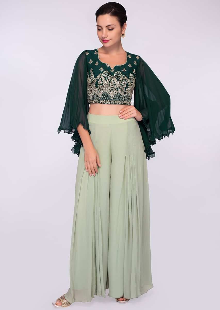 Emerald green silk suit in embroidery and butti paired with a flared 