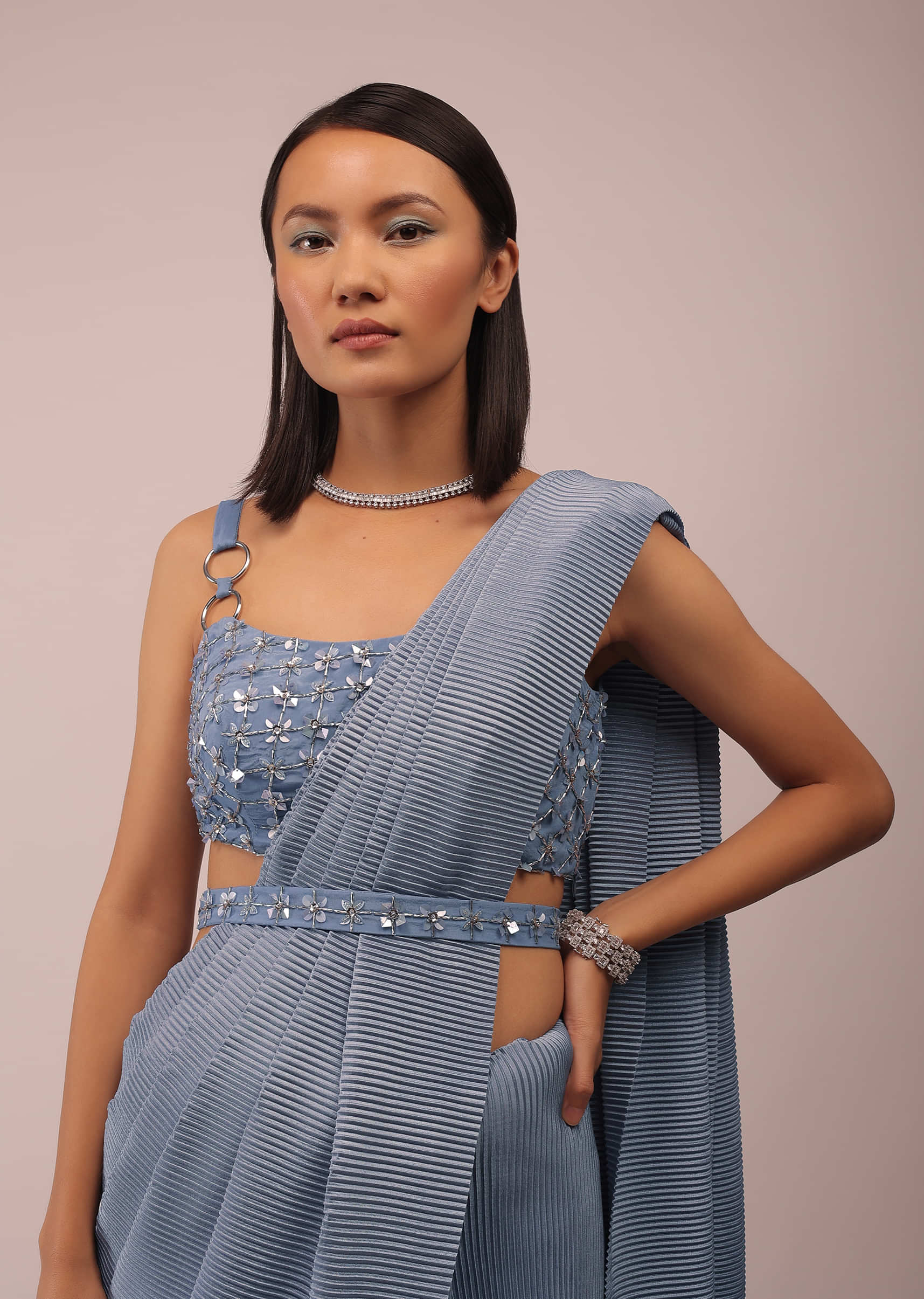 Faded Denim Saree With Buckle Strap Sleeves Crop Top In Sequins Embroidery With An Embroidery Belt In Sequins And 3D Petals
