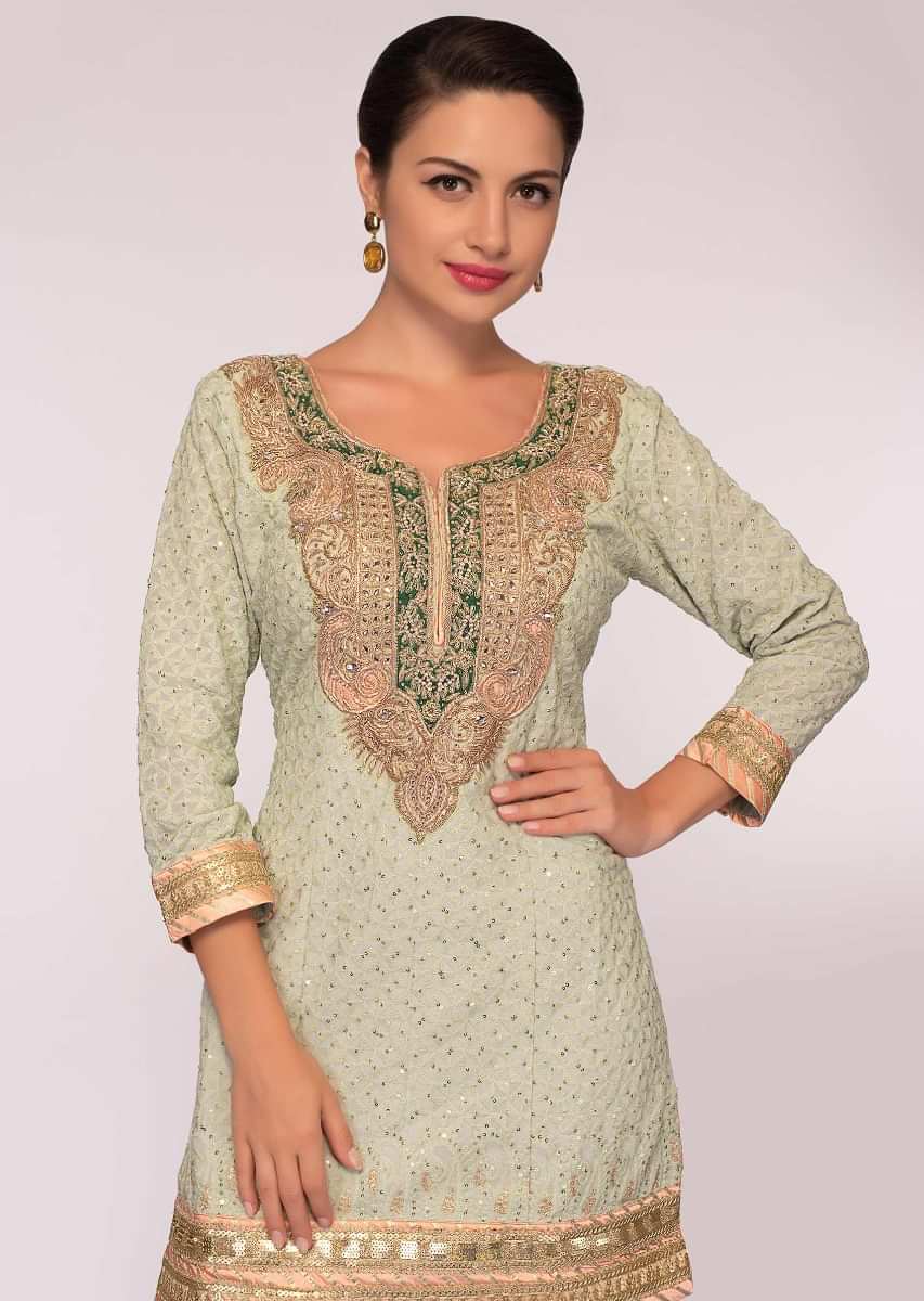 Fern embroidered georgette suit paired with  flared sharara and net dupatta 