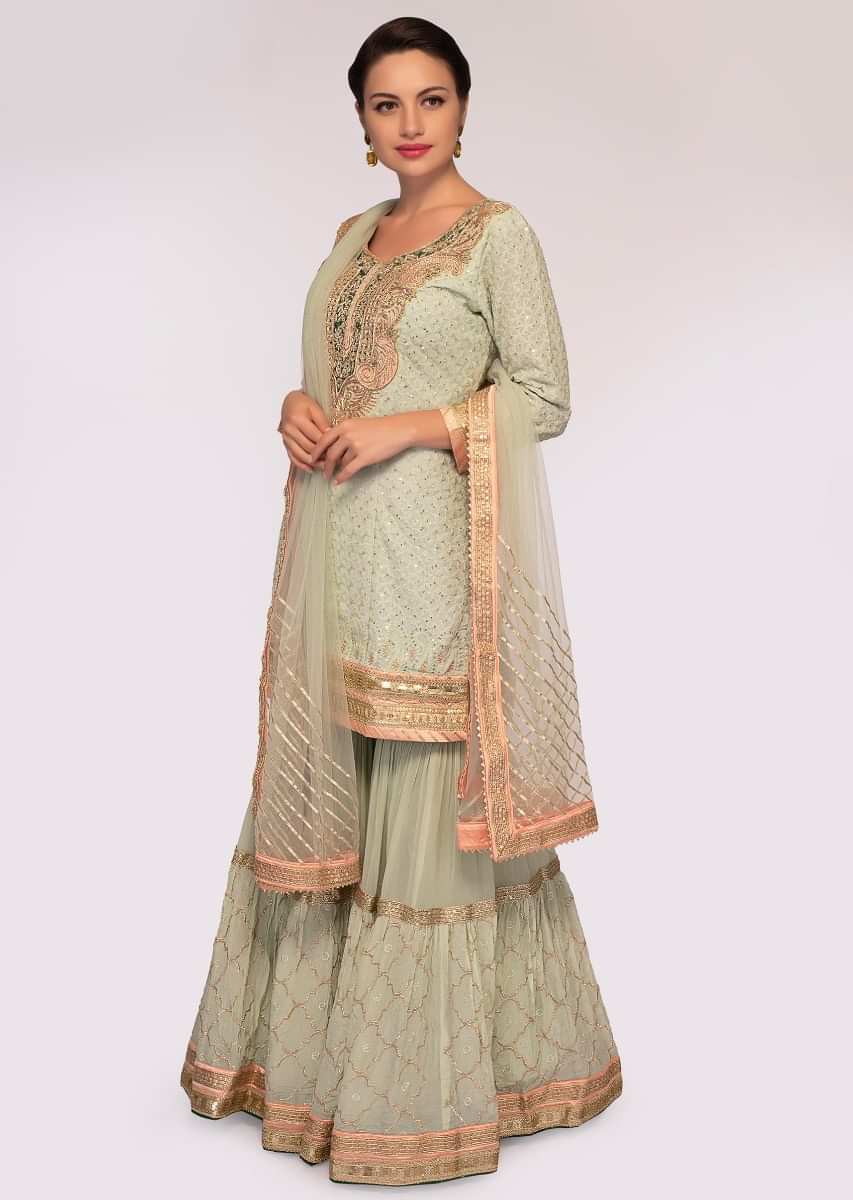 Fern embroidered georgette suit paired with  flared sharara and net dupatta 
