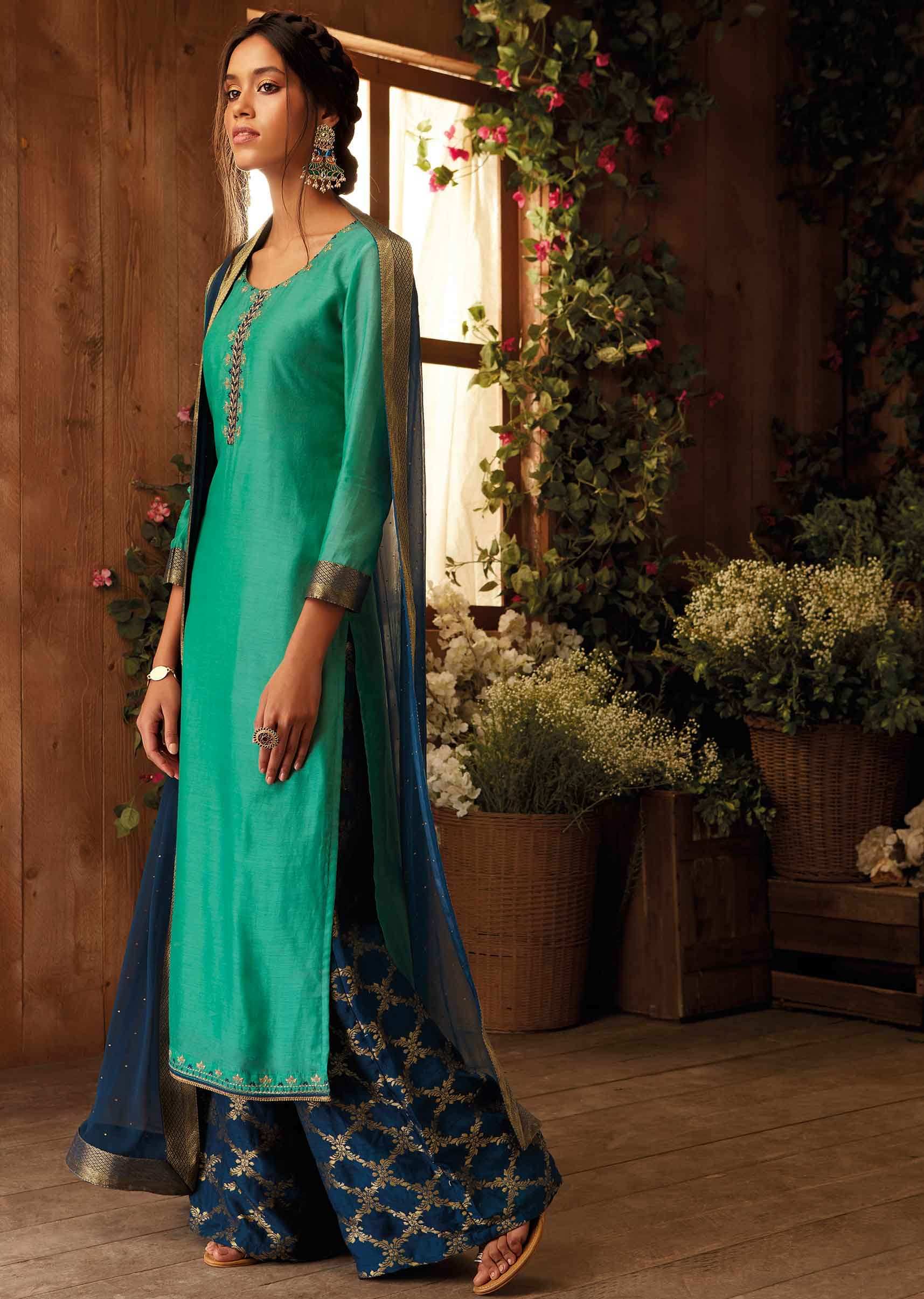 Fern green unstitched suit paired with  floral weaved bottoms and chiffon dupatta with brocade border