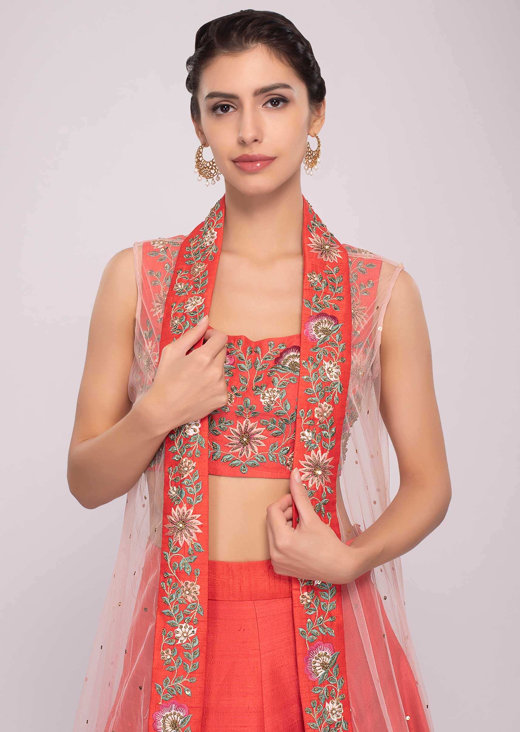 Floral embroidered coral lehenga set paired with long net jacket