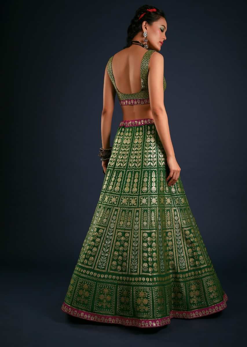 Forest Green Lehenga Set In Brocade Silk With Golden And Silver Woven Kali Design And Contrasting Fuchsia Dupatta 