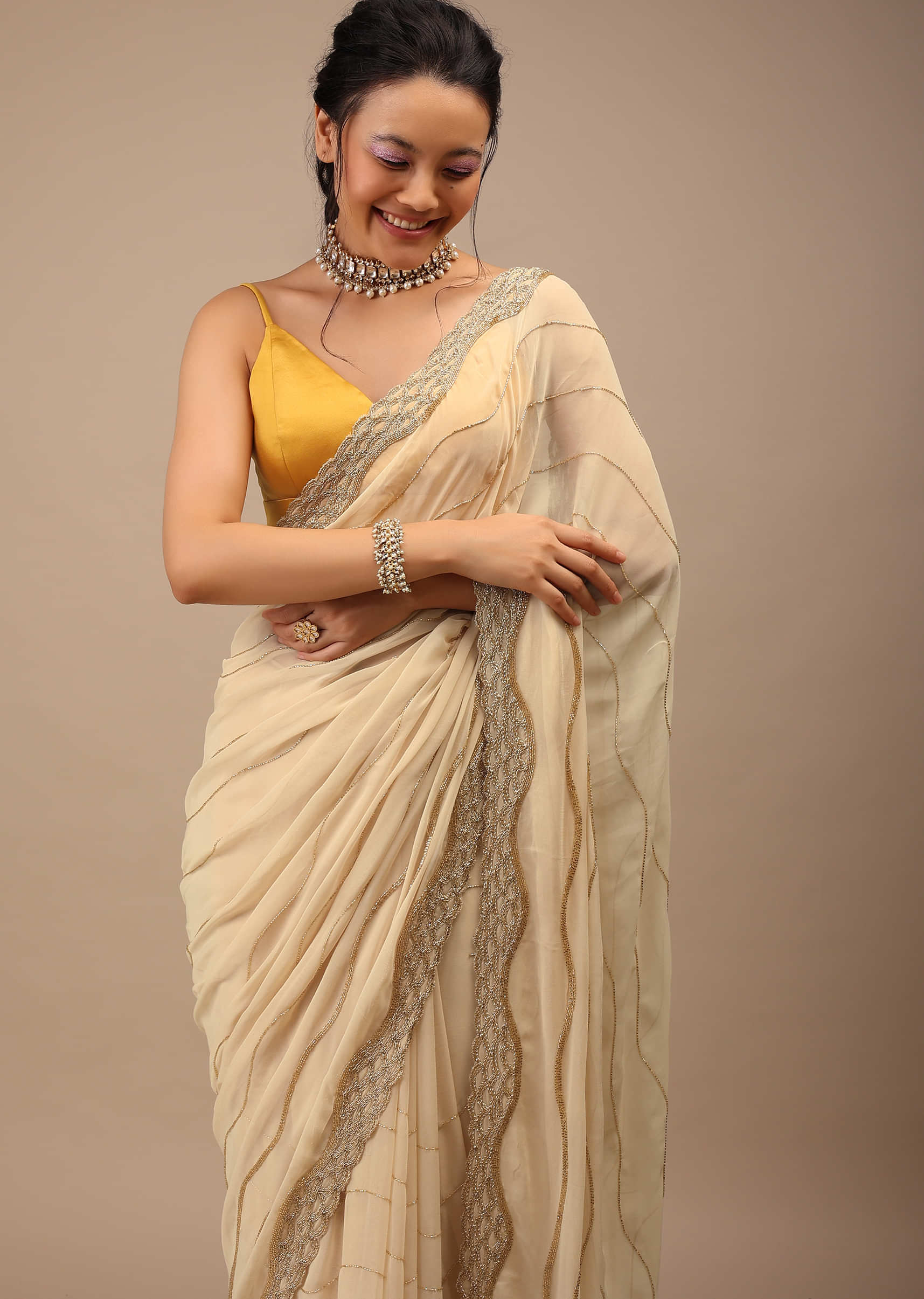 Frozen Dew Georgette Saree Infused With Golden Cut Dana And Copper Detailing 
