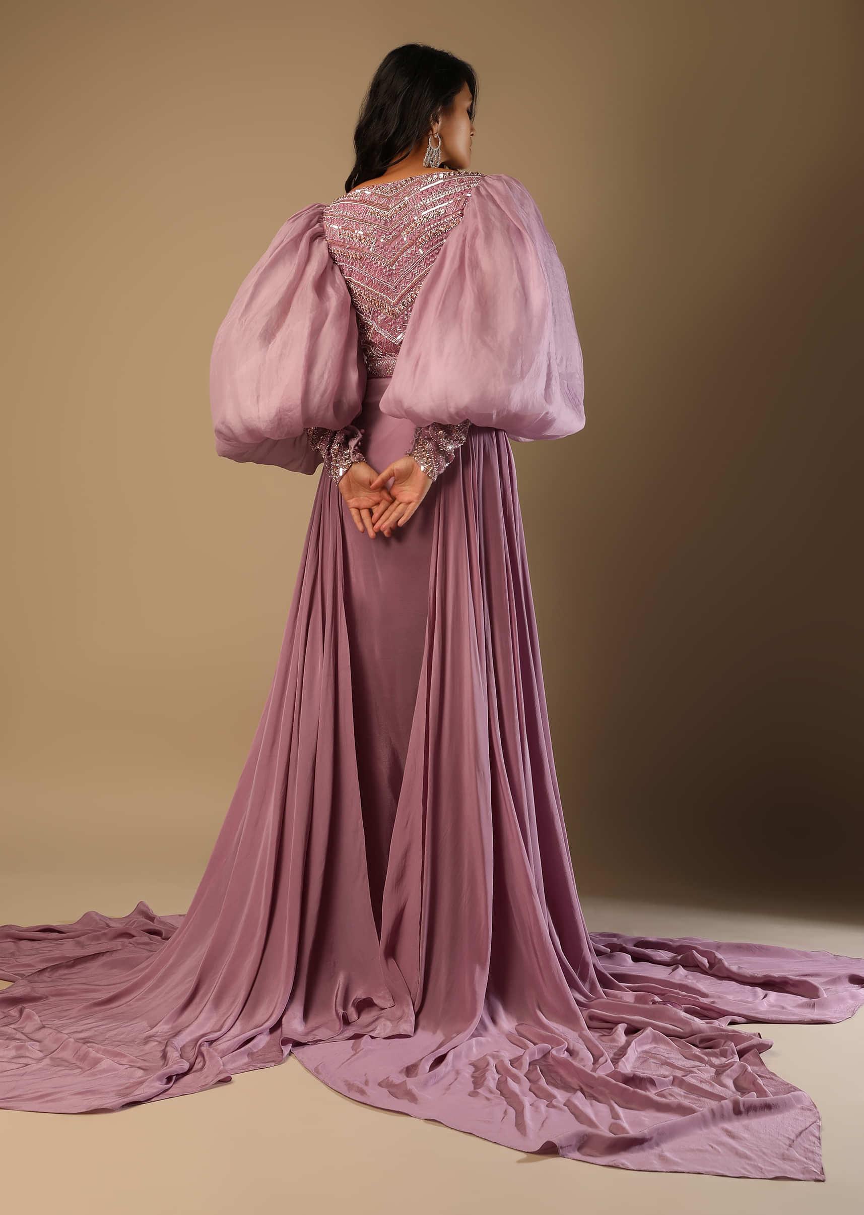 Frozen Mauve Gown With Hand Embroidered Bodice, Balloon Sleeves And A Long Trail  