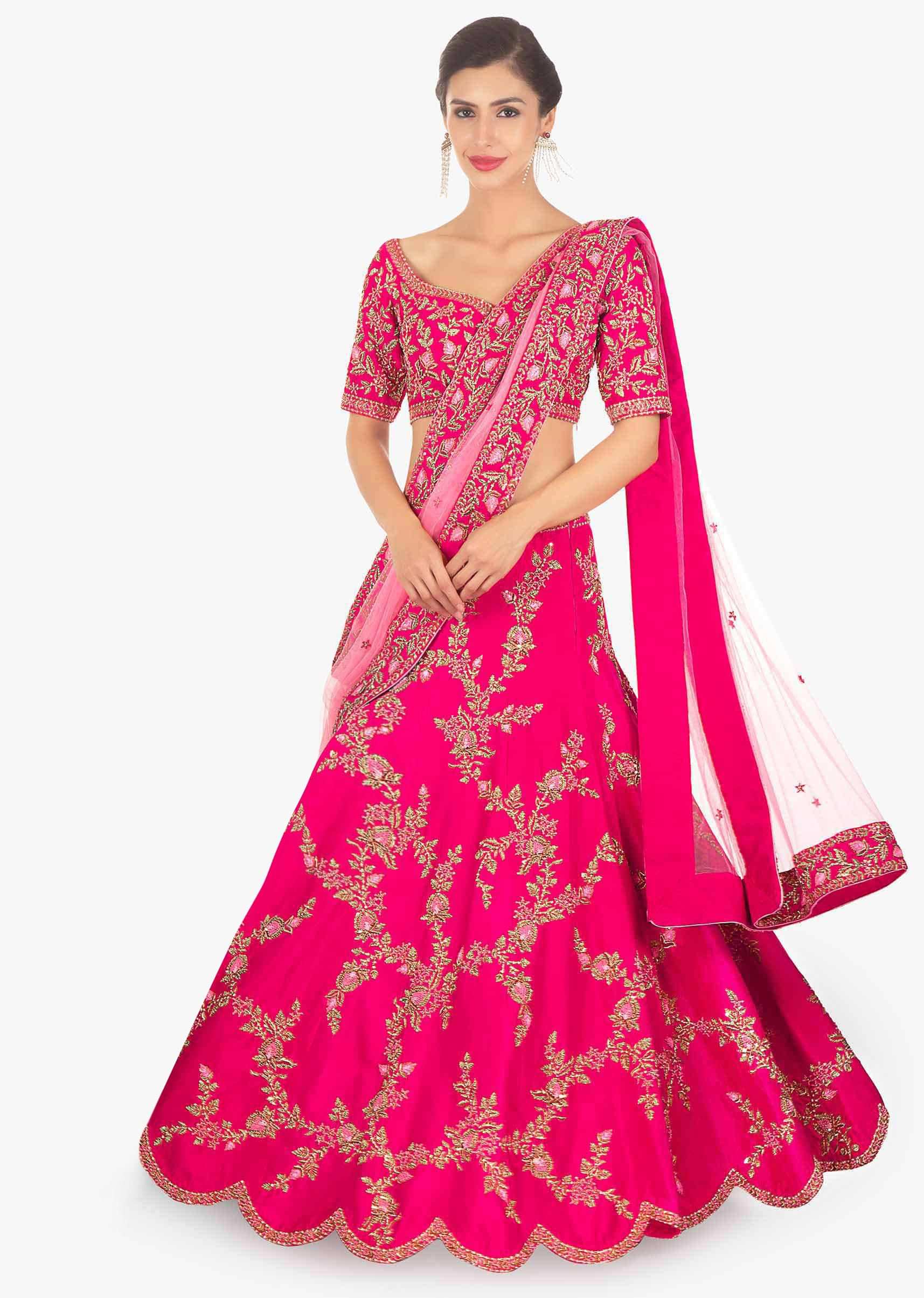 Fuschia pink raw silk lehenga and blouse paired with matching net dupatta 