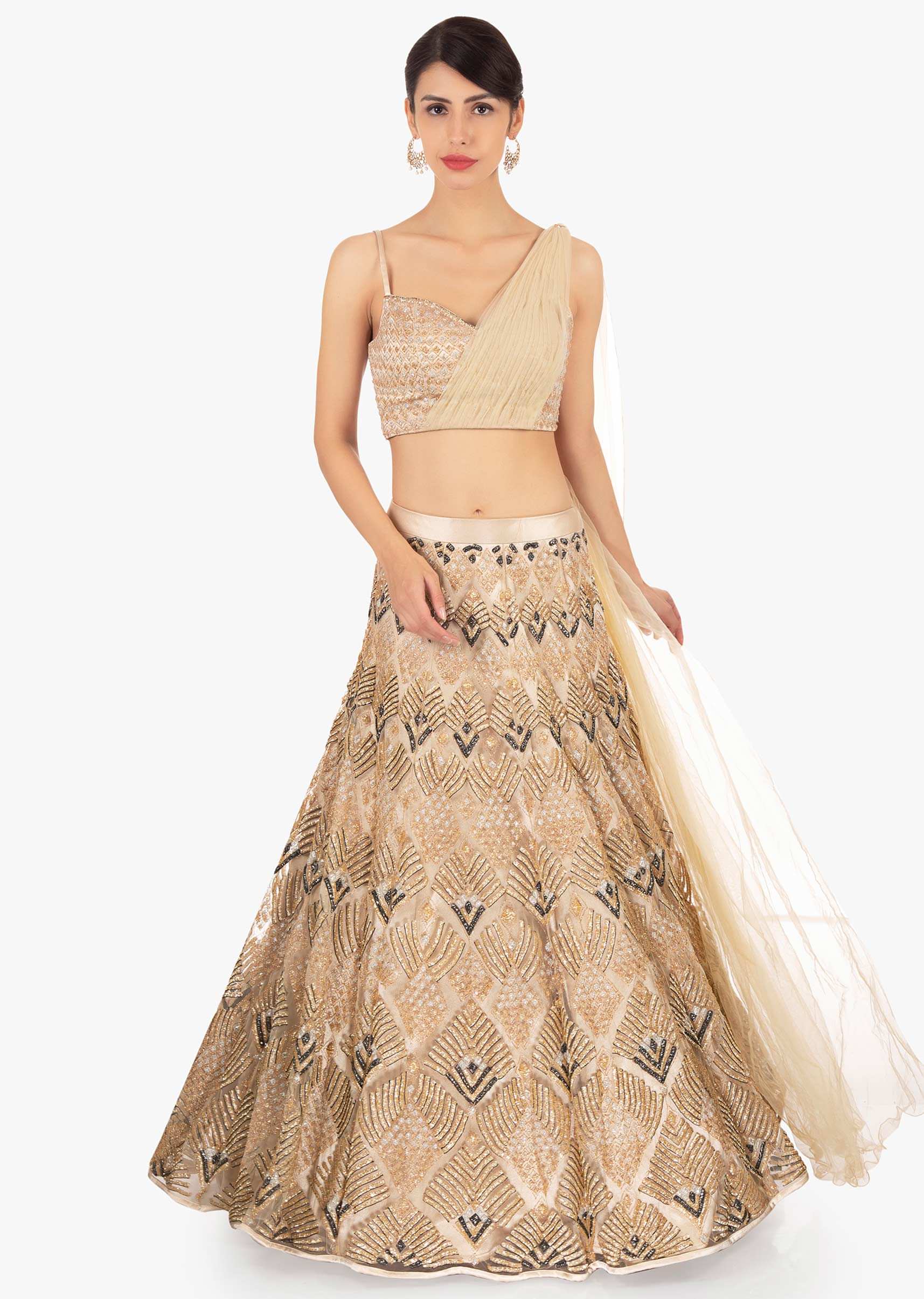Gold net lehenga in geometric motif paired with a strap top with preattached net dupatta