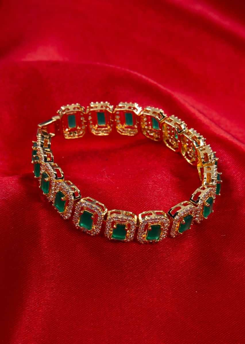 Gold plated bracelet adorn with CZ stones and green beads only on kalki
