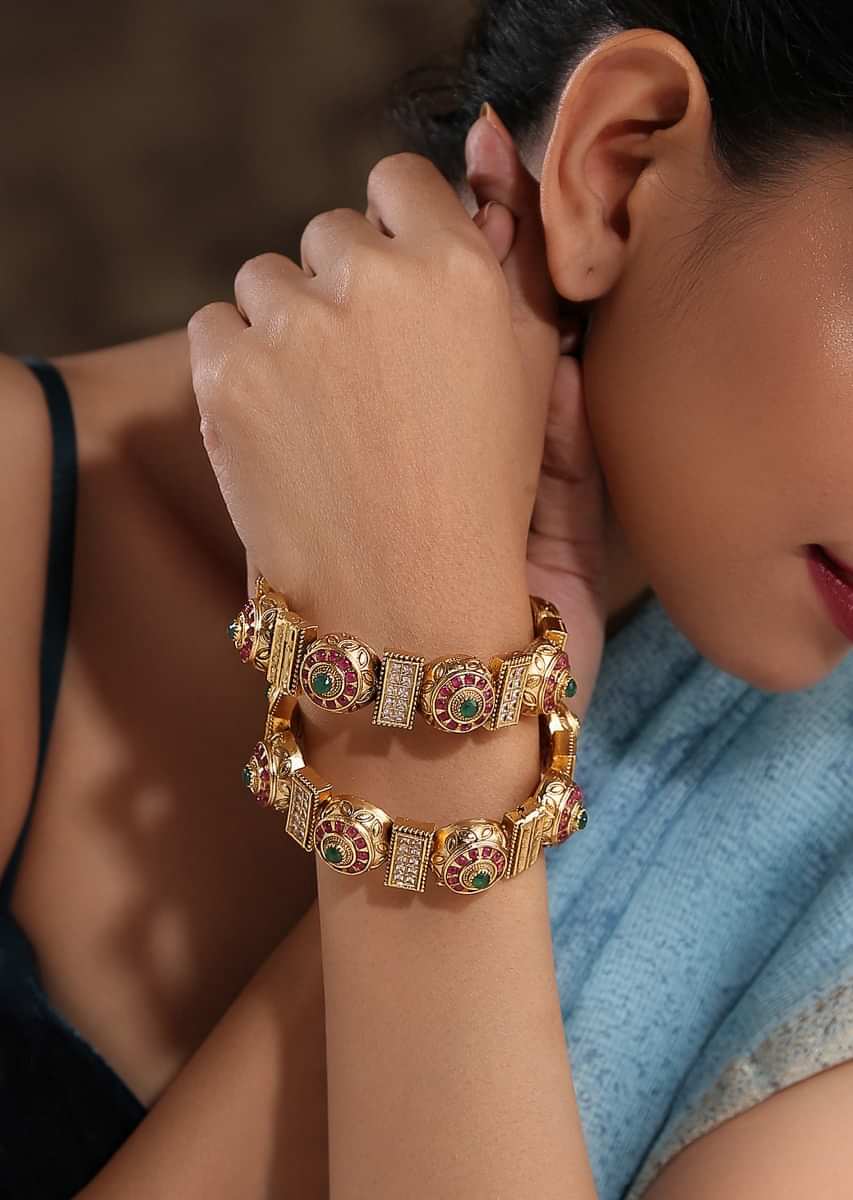 Gold Plated Kundan Bangles With Pink And Green Stones And Embossed Temple Work By Paisley Pop