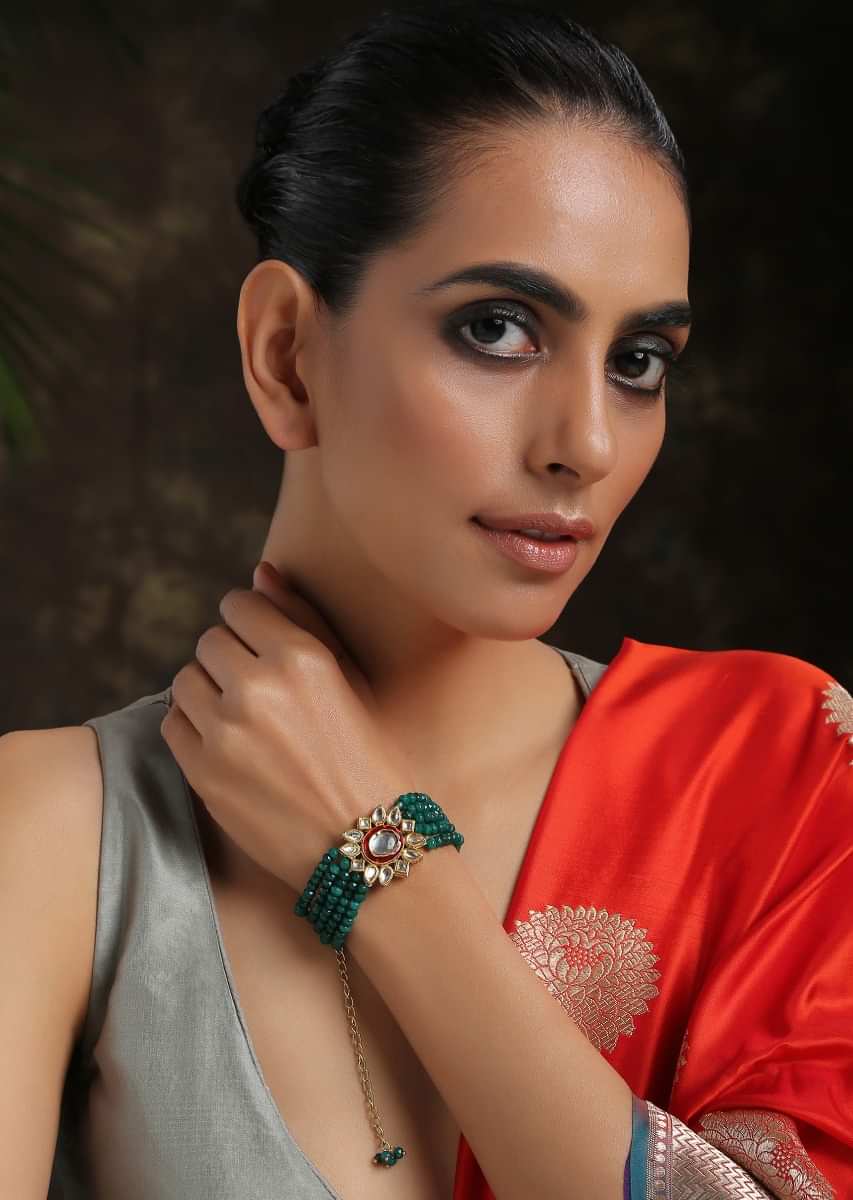 Gold Plated Kundan Bracelet With Emerald Green Stones Bead Strings And Mina Kari Detailing On The Edges By Paisley Pop
