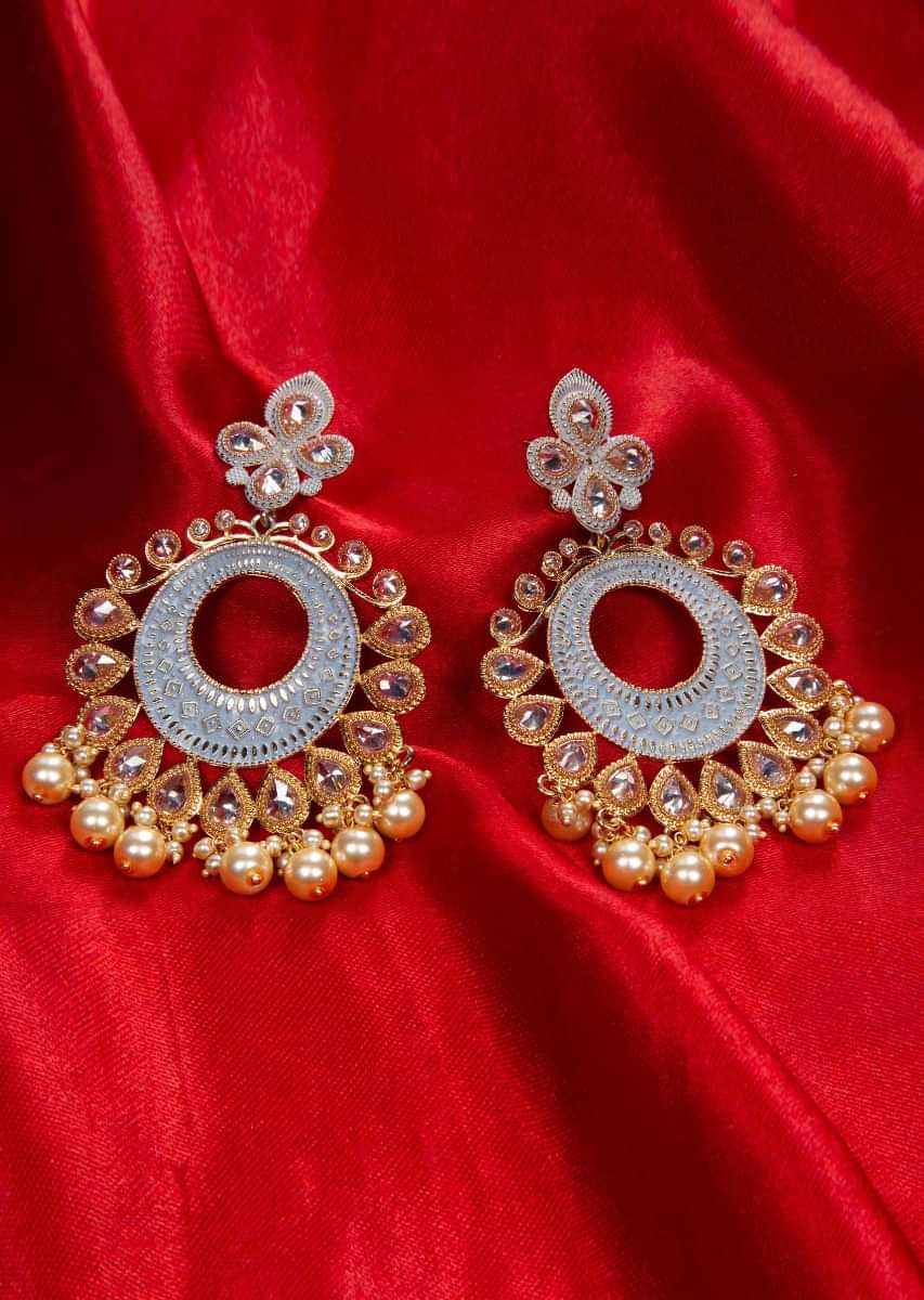 Gold plated self carved traditional earring adorn with crystal beads and dark cream pearls  only on kalki