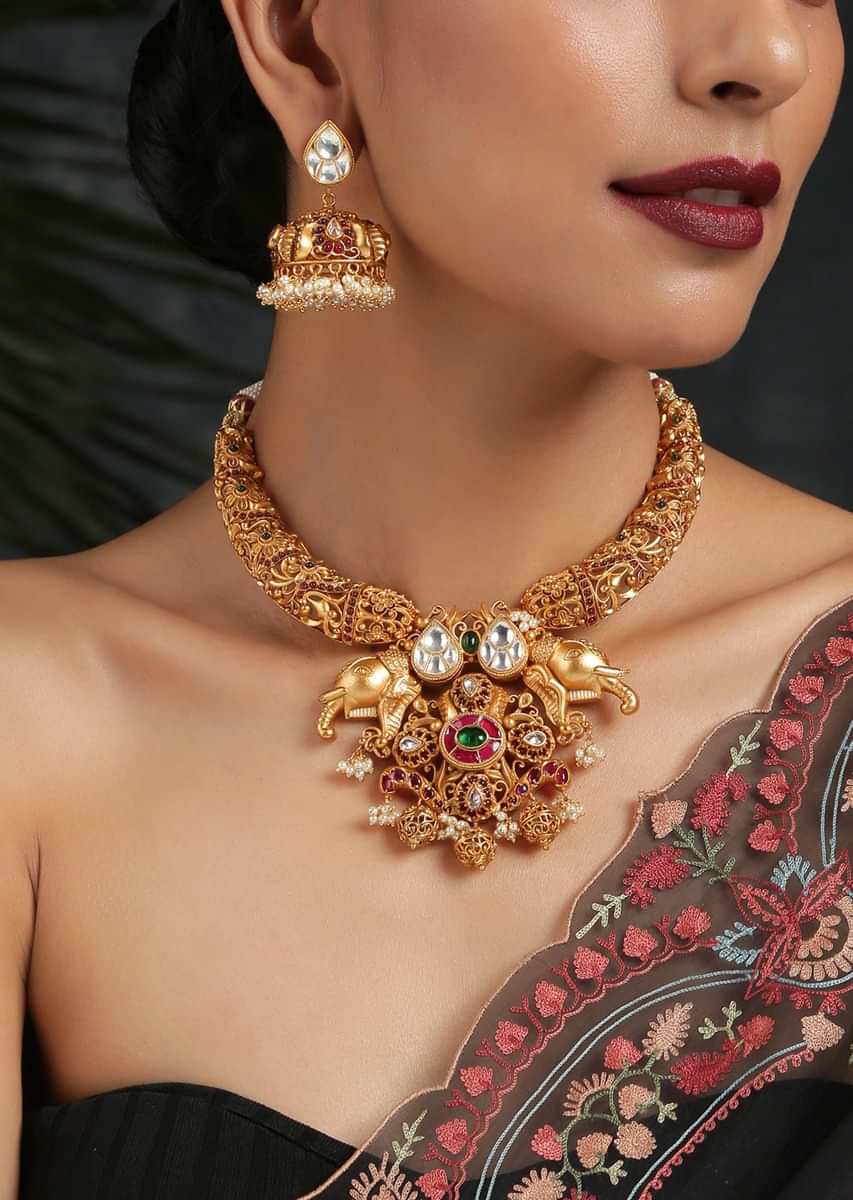 Gold Plated Temple Necklace Set Featuring Embossed Work, Elephant Motif Pendant And Studded With Red Stones By Paisley Pop