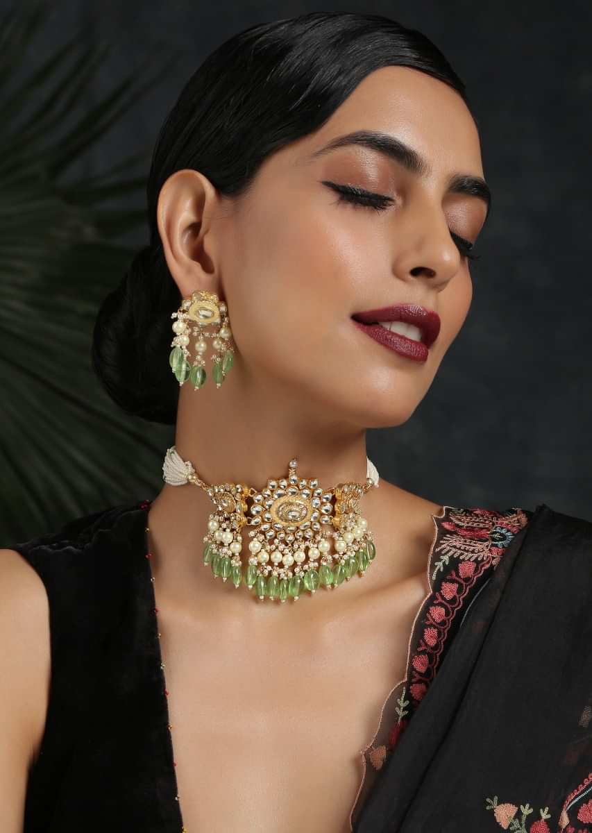 Gold Plated Uncut Kundan Necklace Set With Earrings Embellished With Emerald Green Stones By Paisley Pop