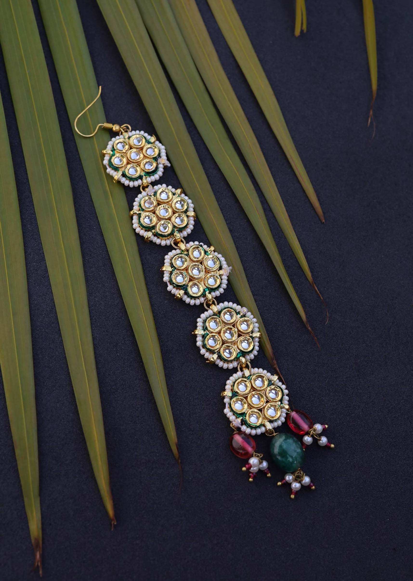 Gold Plated Mangtika With Intricate Kundan Motifs And Dangling Red And Green Stones